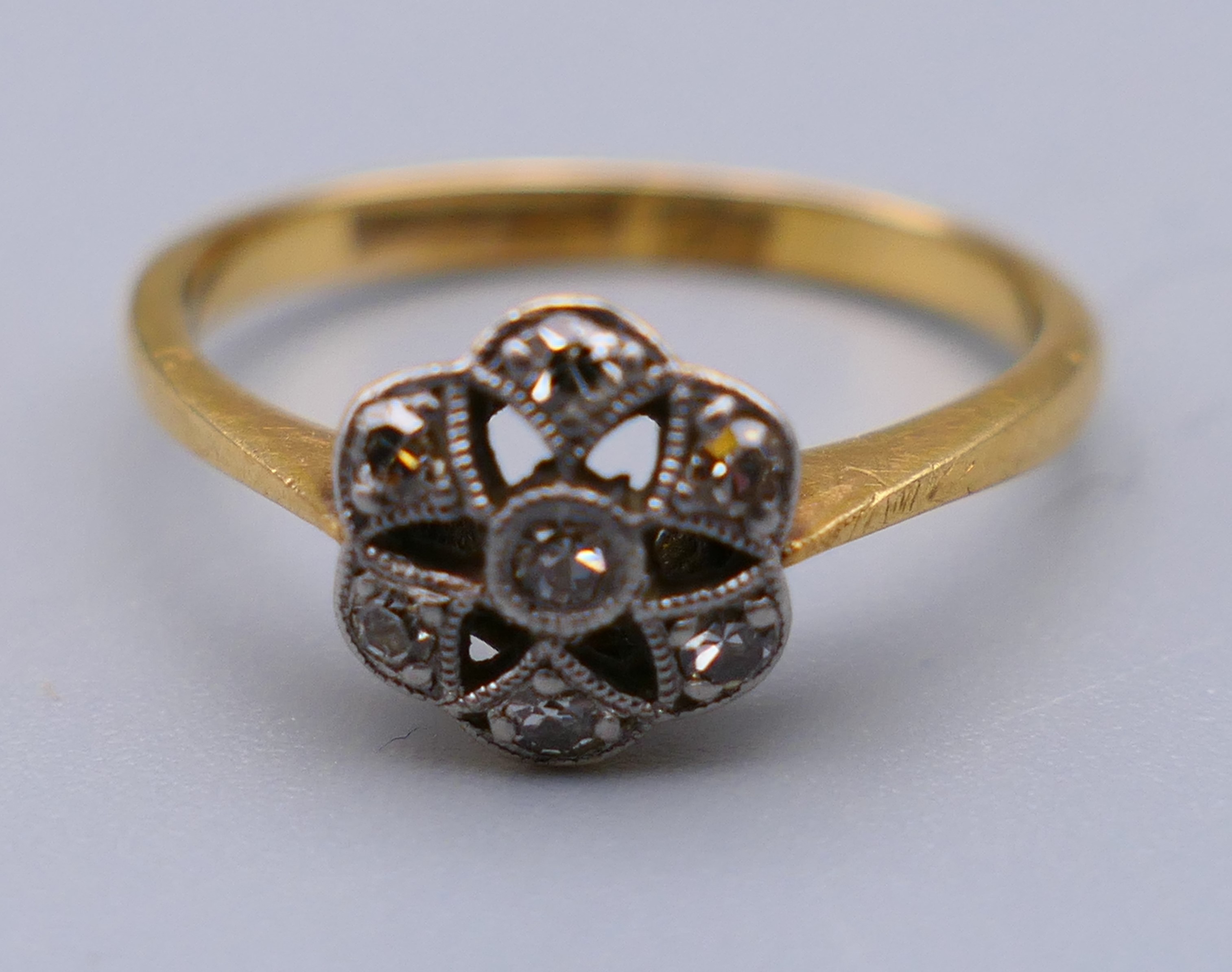 An 18 ct gold and diamond flower head ring. Ring size M. 8 mm high. - Image 6 of 8