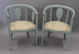 A pair of blue painted tub armchairs. Each 57.5 cm wide.