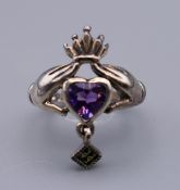 A silver claddagh ring. Ring size I.