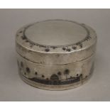 An unmarked Egyptian silver box. 11.5 cm diameter.
