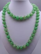 A string of jade beads. 85 cm long.