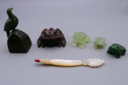 Three jade frogs, a jade bird and a wooden frog. The largest 7 cm high.