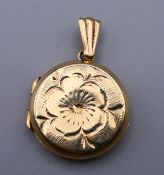 A 9 ct gold double photo locket. 1.5 cm wide. 2.4 grammes.