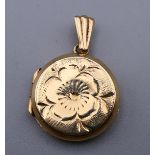 A 9 ct gold double photo locket. 1.5 cm wide. 2.4 grammes.