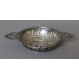 An embossed unmarked silver twin handled dish. 21.5 cm wide. 190.6 grammes.