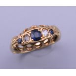 An 18 ct gold diamond and sapphire ring. One diamond missing. Ring size M. 2.3 grammes total weight.