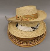 An Oriental straw hat, approximately size 7 1/8 and two straw hats, one by Bailey,