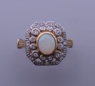 An Art Deco style 9 ct gold, opal and diamond ring. Ring size M/N.