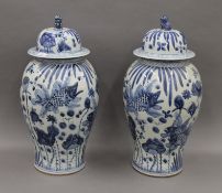 A pair of large Chinese blue and white porcelain lidded vases. 61 cm high.