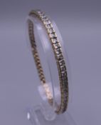 A 9 ct gold tennis bracelet set with white stones. 19.5 cm long. 17.1 grammes total weight.