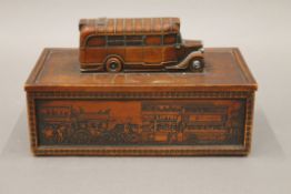 A games box, the lid surmounted with a vintage bus. 20 cm wide.