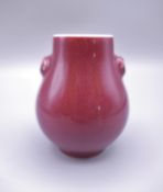 A miniature Chinese sang de boeuf vase. 8 cm high.