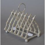 A silver plated rifle form toast rack. 11.5 cm long.