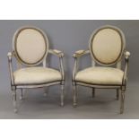 A pair of upholstered 19th century painted open armchairs. 59 cm wide.