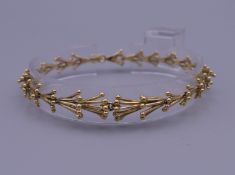 An 18 ct gold bracelet by John Donald. 18.5 cm long. 14.3 grammes.