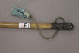 A Victorian silver mounted rhino horn riding crop. 75 cm long.