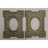 A pair of embossed brass clad picture frames. Each 21 x 28 cm.