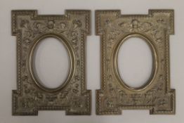 A pair of embossed brass clad picture frames. Each 21 x 28 cm.