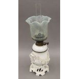A blanc de chine oil lamp with vaseline glass shade. 56 cm high overall.