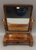 A Victorian mahogany two-drawer toilet mirror. 54 cm wide.