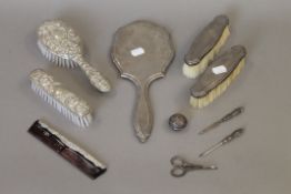 A quantity of silver backed brushes, etc., and a cased manicure set.