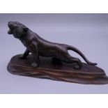 A Japanese bronze model of a tiger, on a wooden base. The tiger 13 cm long.