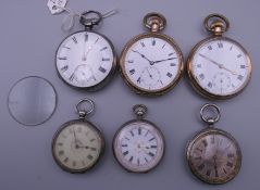 A small collection of pocket watches, some silver.