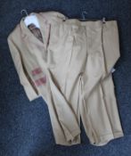 A beige suit with two pairs of trousers.