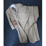 A beige suit with two pairs of trousers.
