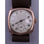 A gentleman's 9 ct gold cased wristwatch. 3 cm wide.