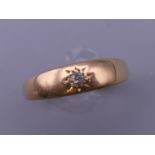 An 18 ct gold gypsy set diamond ring. Ring size Q. 3.1 grammes total weight.