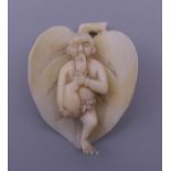 A small late 19th/early 20th century ivory carving formed as a figure on a leaf. 4.5 cm high.