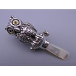A silver owl rattle. 8.5 cm high.