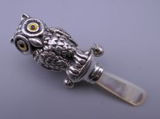 A silver owl rattle. 8.5 cm high.