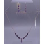 A 9 ct gold amethyst set necklace and earrings en-suite. The necklace 42 cm long. 7.