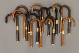 A quantity of walking stick/parasol handles.