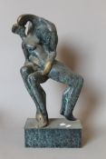 An abstract patinated bronze sculpture of a couple kissing. 44 cm high.