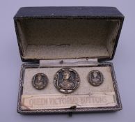 Three cased Queen Victoria buttons.