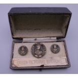 Three cased Queen Victoria buttons.