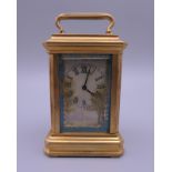 A miniature painted porcelain carriage clock. 8.