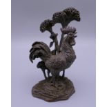 A bronze model of a cockerel. 9 cm high.