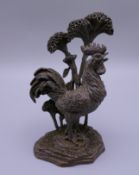 A bronze model of a cockerel. 9 cm high.