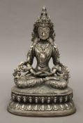 A silvered bronze model of a Buddha. 21.5 cm high.