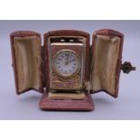 A miniature chinoiserie enamel decorated silver carriage clock in case. 4 cm high.