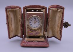 A miniature chinoiserie enamel decorated silver carriage clock in case. 4 cm high.