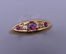 A 18 ct gold diamond and ruby ring. Ring size N. 2 grammes total weight.