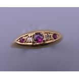 A 18 ct gold diamond and ruby ring. Ring size N. 2 grammes total weight.