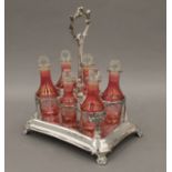 A cranberry glass silver plated cruet stand. 28.5 cm high.