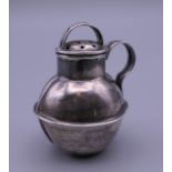A miniature silver pepper pot formed as a Jersey milk churn. 4 cm high. 10.4 grammes.