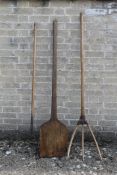 A bread paddle and two vintage hay forks.